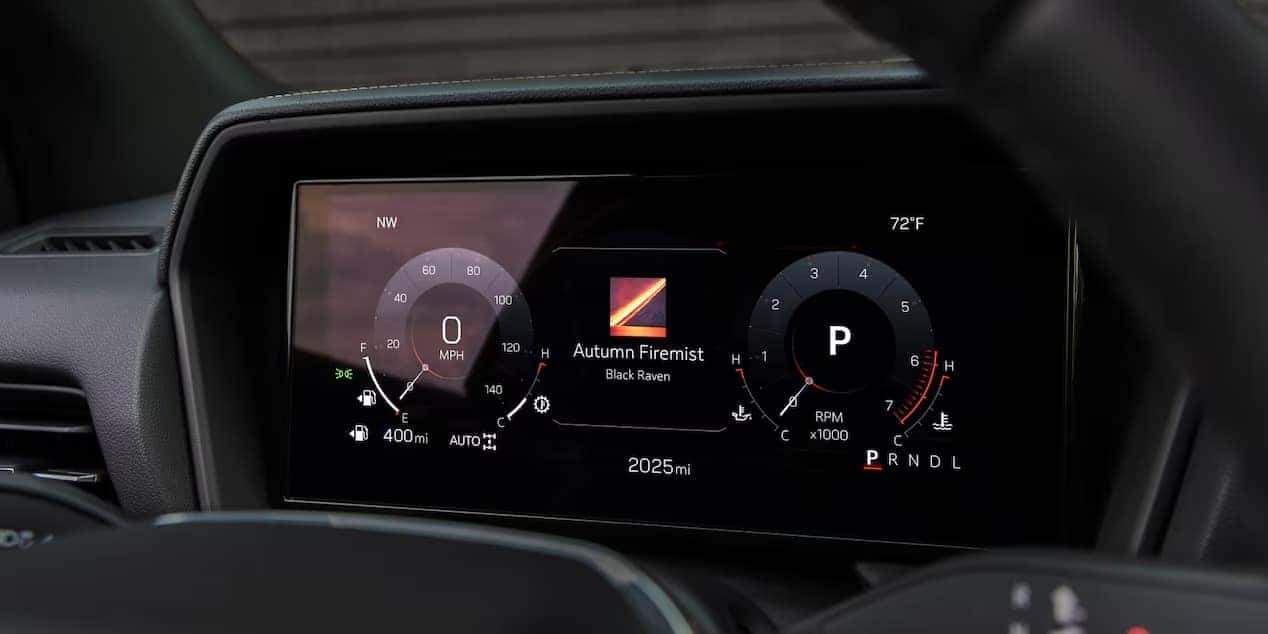 A digital car dashboard display showing speed in 0 MPH, temperature at 72°F, and RPM at 0. The center displays the track Autumn Firemist by Black Raven. The odometer reads 2025 miles. Gear indicator is set to P.