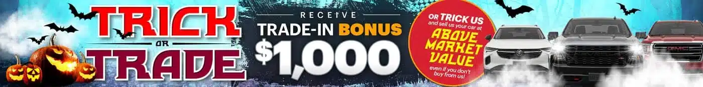 Halloween-themed car trade-in promotion offers $1,000 bonus above market value, featuring pumpkins and bats.
