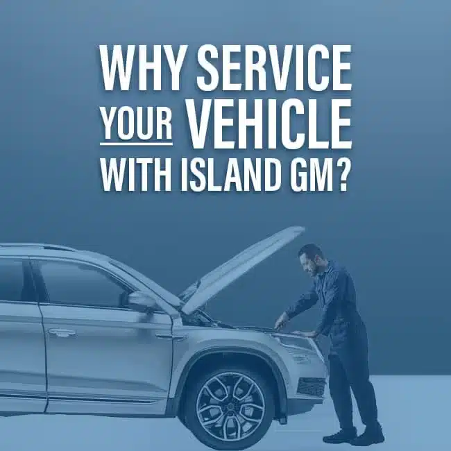 Mechanic servicing a car emphasizes Island GM's vehicle maintenance benefits.