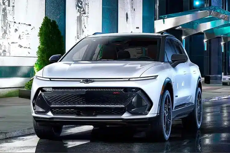 Sleek white electric SUV parked on urban street, showcasing modern design and cutting-edge technology.
