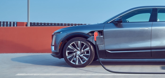 Electric car charging at a station, showcasing eco-friendly transportation and modern vehicle design.