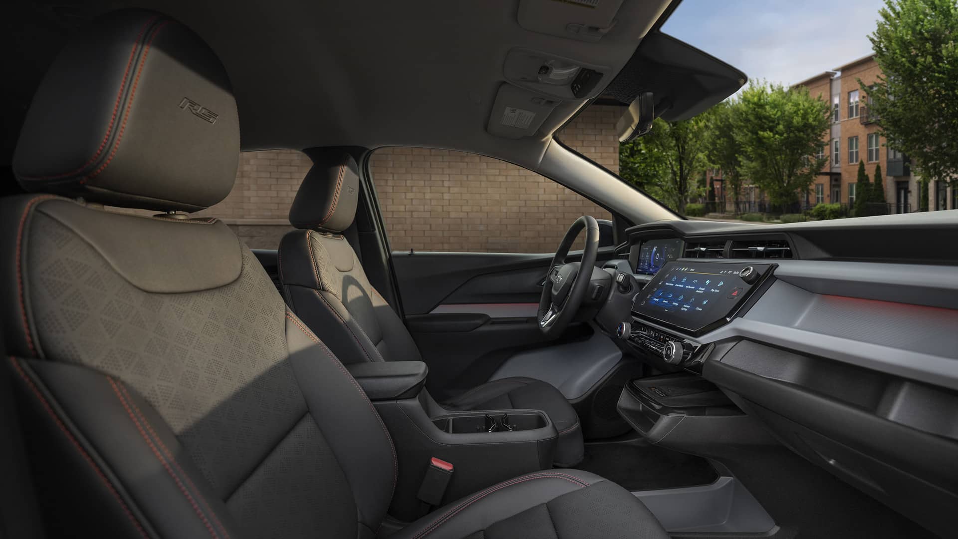 Modern car interior with black seats, accented stitching, and a digital dashboard display.