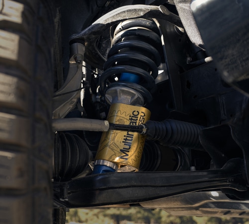 Close-up of a vehicle's Multimatic DSSV shock absorber and suspension system detail.