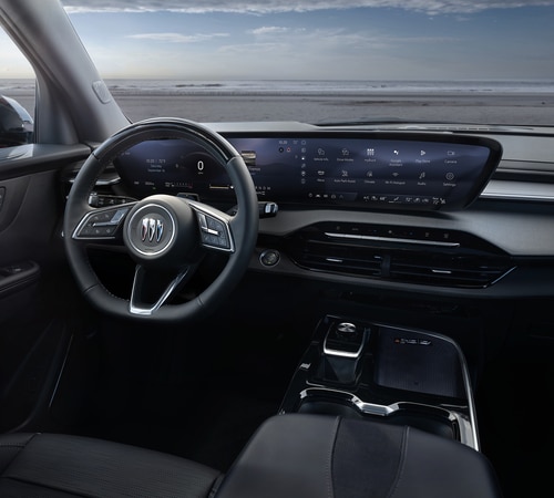 Modern car interior featuring a sleek dashboard, digital display, and steering wheel with a prominent logo.